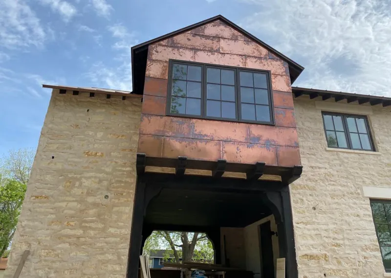 Copper metal panel facade on a stone building for Metal Roof Coating in Smithville